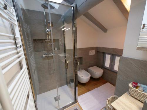 a bathroom with a shower and a toilet at Ak House in Aprica