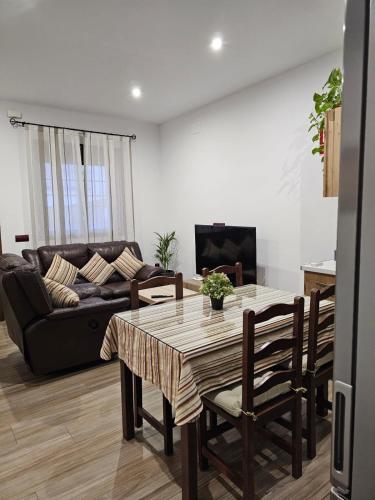 a living room with a table and a couch at Nalkia in Villanueva de la Concepción