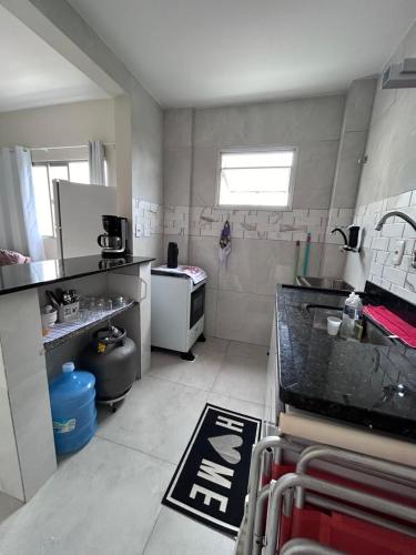 a small kitchen with a sink and a stove at EDIF. ELIAS PINTO COELHO, APTO. 304 in Guarapari