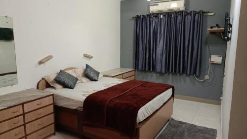 a bedroom with a bed and a shower in it at Bungalow at Porvorim, Panaji in Panaji