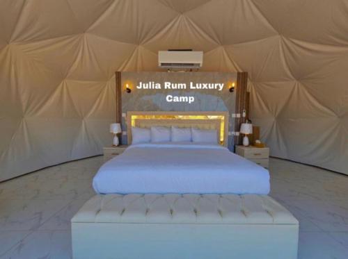 a bedroom with a bed in a tent at Julia Rum Luxury Camp in Wadi Rum
