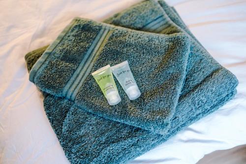 a blue bag with a toothbrush and a tube of tooth paste at 4 Bedroom Victorian House in Manchester