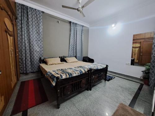 a bedroom with a bed and a ceiling fan at 3 Bedroom Duplex Villa With Private Pool Bangalore in Bangalore