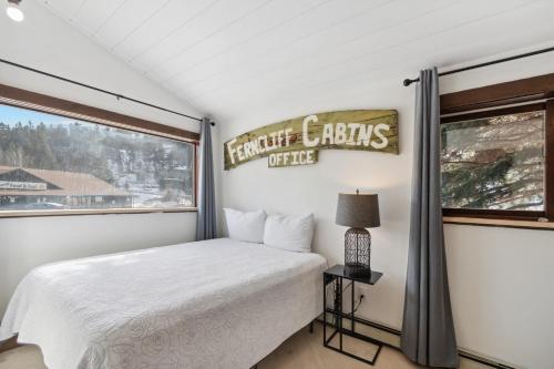 a bedroom with a bed and a window at 5 Bd Cabin W Private Hot Tub in Allenspark