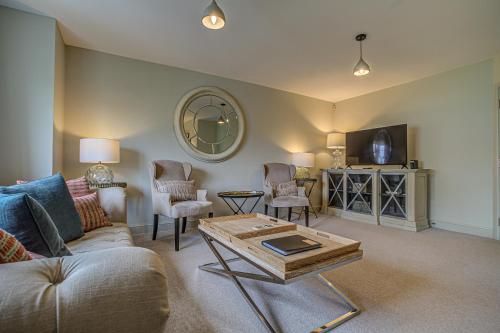 a living room with a couch and a coffee table at The Vanbrugh Suites in Oxford