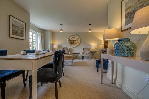 a living room with a table and chairs and a dining room at The Vanbrugh Suites in Oxford