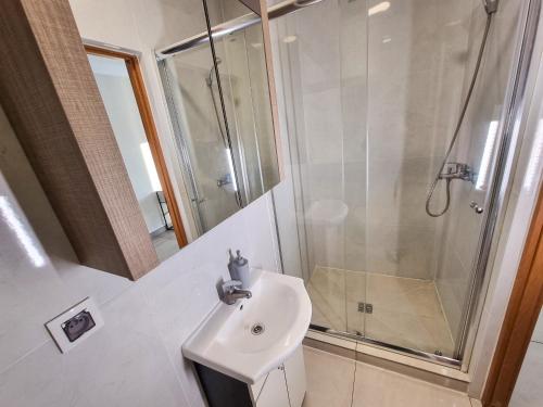 a bathroom with a sink and a shower at Orange Tree Hotel in Będzin
