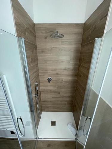 a bathroom with a shower with a glass door at La Casina di Cinzia in San Gimignano