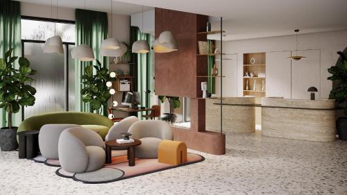 a lobby with a waiting room with chairs and tables at Residence Inn by Marriott Geneva City Nations in Geneva