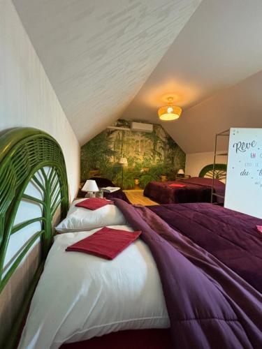 a room with two beds with a sign on the wall at Le Bleu de B. in Saint-Étienne-en-Bresse