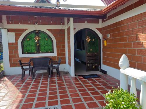 a patio with a table and chairs and a door at HOTEL VILLA DANIELA in Puerto Triunfo