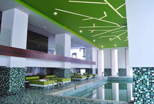 eine Hotellobby mit Pool und grüner Decke in der Unterkunft Apartamento en el Barrio de POLANCO . GREAT APARTMENT/ MEXICO CITY in Mexiko-Stadt
