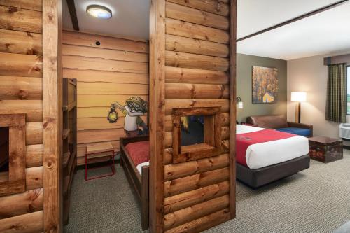 a hotel room with a bedroom and a bed at Great Wolf Lodge New England in Leominster