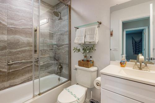 a bathroom with a shower and a toilet and a sink at Dreaming on the Canal in Port Charlotte