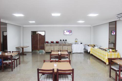 a restaurant with tables and chairs and a buffet at Days inn by Wyndham Uberlândia in Uberlândia