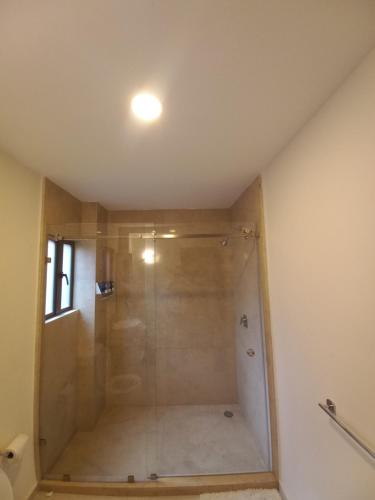 a shower with a glass door in a bathroom at Maria Blanca in Santeagueda