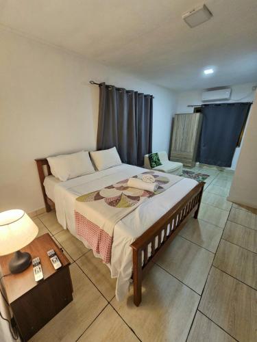 a bedroom with a large bed in a room at Alpha & Omega Apartment Seychelles in Beau Vallon
