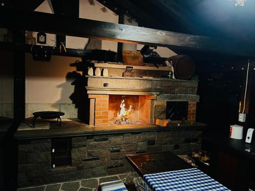 a brick fireplace with a fire in it at Vila Eell in Borsa