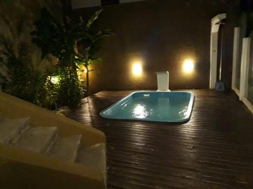 a bath tub sitting on top of a wooden floor at Loft em Caldas da Imperatriz - SC in Santo Amaro da Imperatriz