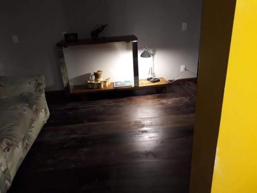 a room with a mirror and a wooden floor at Loft em Caldas da Imperatriz - SC in Santo Amaro da Imperatriz