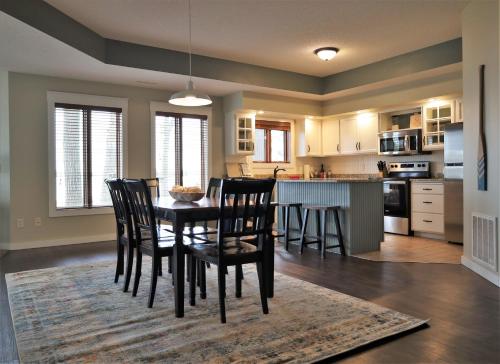 a kitchen and dining room with a table and chairs at Bay Colony 761 - Lower in Nisswa
