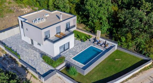 an overhead view of a house with a swimming pool at Luxury Villa Oriolus, heated pool, sauna, Split in Srinjine