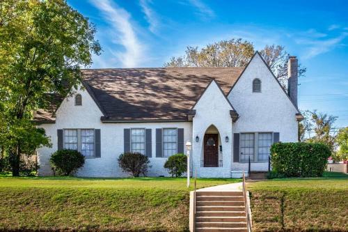 a white house with a staircase in front of it at New Comfy Bungalow on Washington-Dedicated Office in Waco