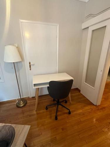 a desk in a room with a lamp and a chair at Central House in Plaka in Athens