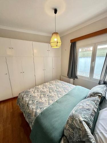 a bedroom with a bed and a window at Central House in Plaka in Athens