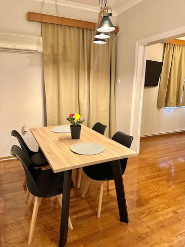 a wooden table with black chairs in a room at Central House in Plaka in Athens