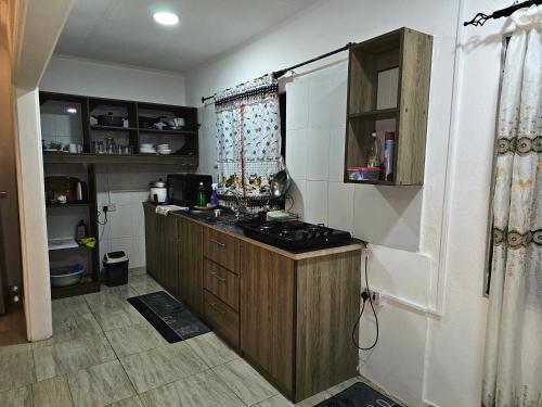 a kitchen with a counter and a stove in it at Alpha & Omega Apartment Seychelles in Beau Vallon