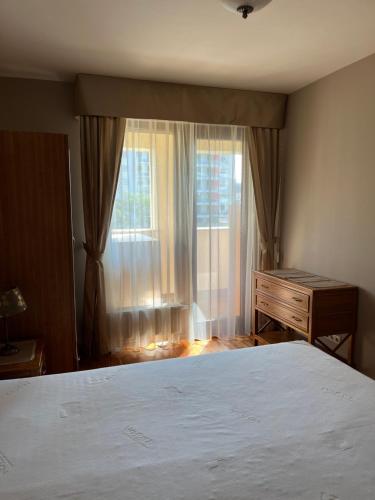 a bedroom with a bed and a dresser and a window at Perfect Relax in Budapest