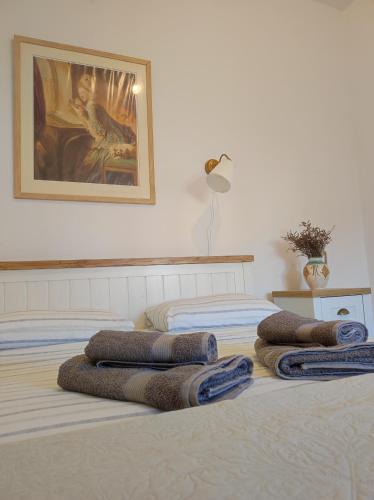 two beds in a bedroom with towels on them at Nicola's House in Myrina
