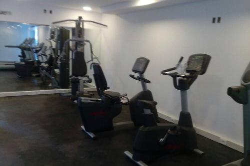 a gym with several tread machines in a room at Departamentos en Uruguay al río, Dos Orillas, Colonia in Colonia del Sacramento