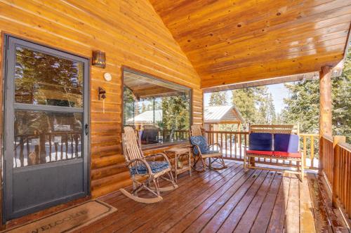 a cabin with a porch with a table and chairs at Duck Creek Village Cozy Cabin Near Fishing and ATV in Duck Creek Village