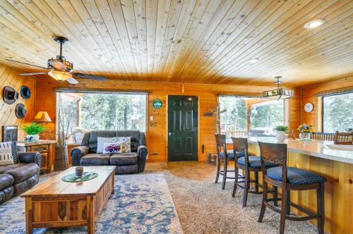 a living room with a table and chairs and a kitchen at Duck Creek Village Cozy Cabin Near Fishing and ATV in Duck Creek Village