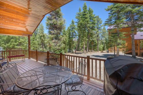 a patio with a table and chairs on a deck at Duck Creek Village Cozy Cabin Near Fishing and ATV in Duck Creek Village