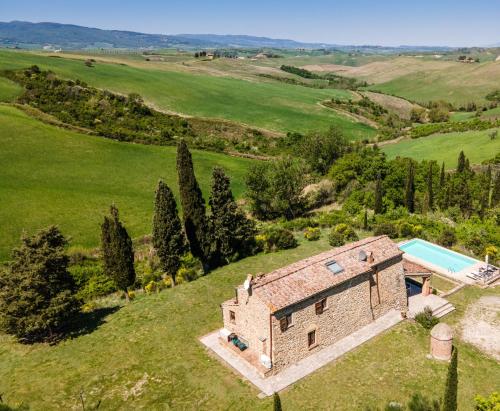 an aerial view of a stone house with a swimming pool at Villa Cantucci in Volterra