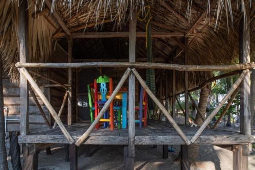 a thatched hut with a table with books in it at Cabañas Casa de Agua in Boca del cielo