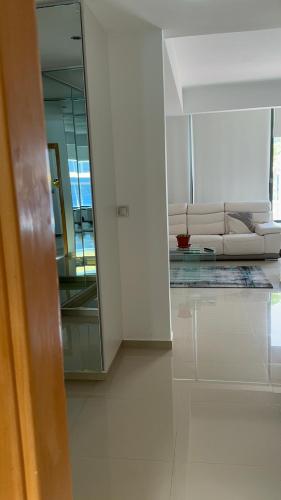 a living room with a white couch and a mirror at Appartement Sao Filipe in Praia