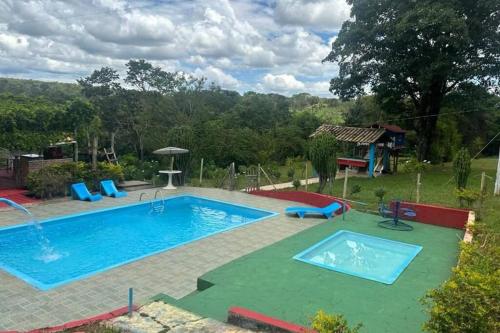 a large swimming pool with a playground and a slide at Sítio Pousadinhas do Lago in Almeida