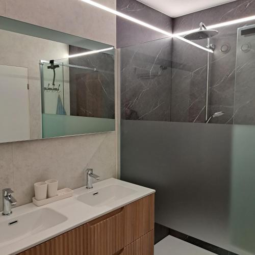 a bathroom with a sink and a shower at Appartement Residentie Amadeus met garage-lift in Sint-Idesbald