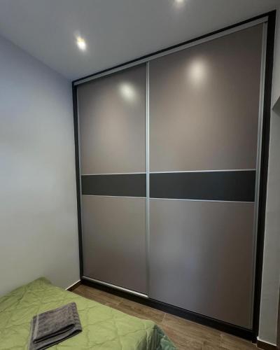 a sliding glass door in a room with a bed at Central Stylish Lux Apartments in Lamía