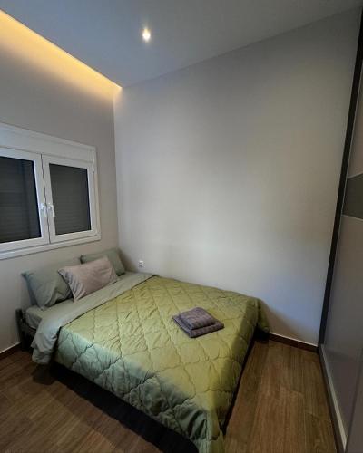a bedroom with a bed and two windows at Central Stylish Lux Apartments in Lamía