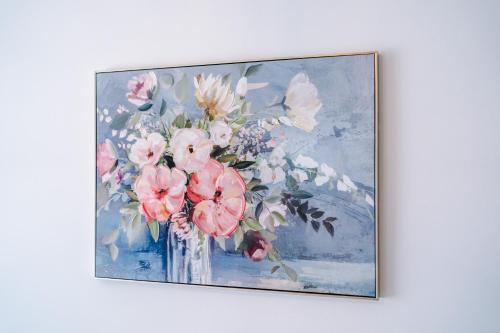 a painting of a vase of flowers on a wall at The Retreat near Salford Quays in Manchester