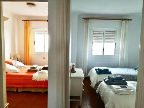 Ein Bett oder Betten in einem Zimmer der Unterkunft Las Casas de Mar Zahara de los Atunes