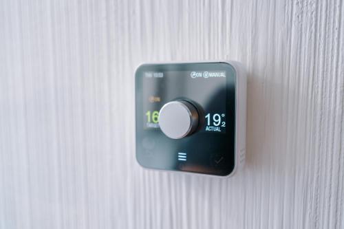a switch on a wall with a clock on it at The Retreat near Salford Quays in Manchester