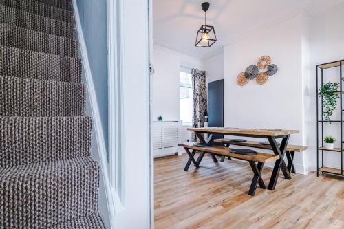 a room with a table and a staircase at The Retreat near Salford Quays in Manchester