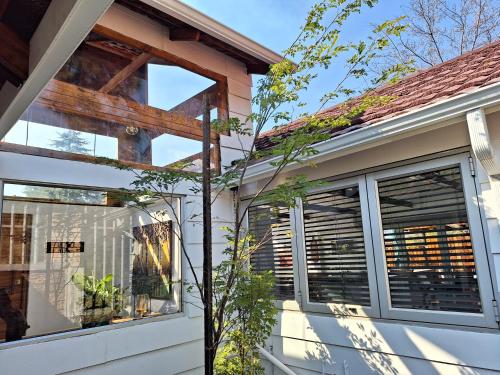 a house with sliding glass doors on the side of it at Tree Living in Krugersdorp