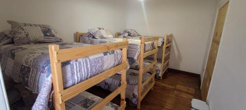 two bunk beds in a room with a bed at Scorpius Hostel in Vicuña